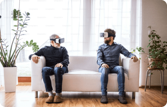 Two people in a couch with Virtual Reality Headsets